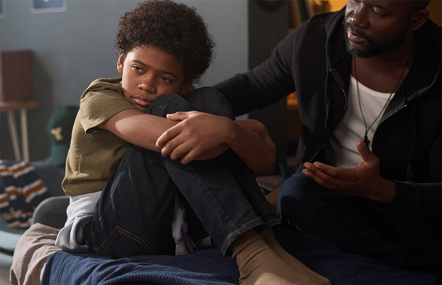 Photo of a father talking to his son