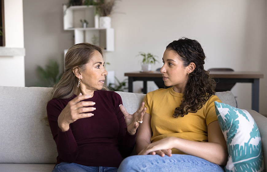 Photo of a mother talking to her teenage daughter