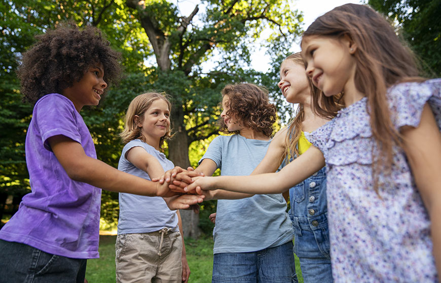 Photo of happy kids with all hands in