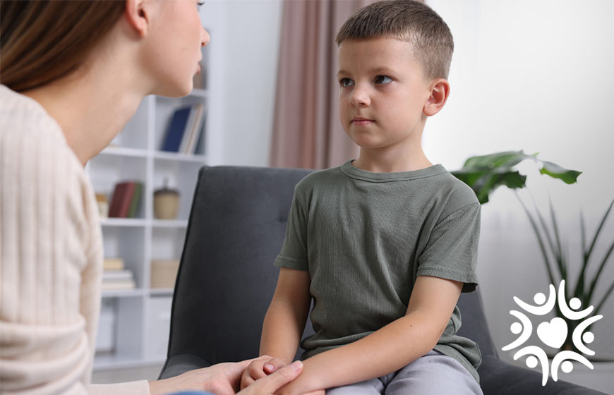 Photo of a woman talking to a little boy